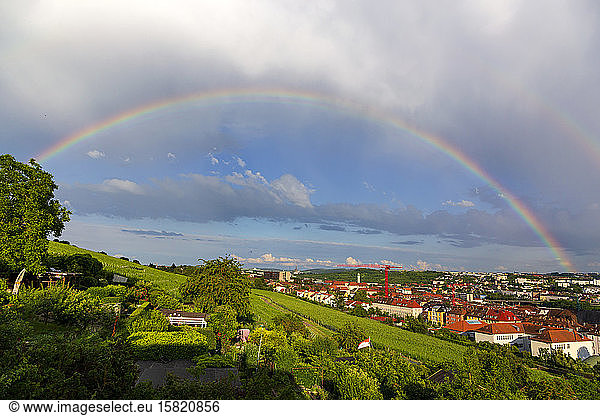 Germany  Bavaria  Wurzburg  Rainbow over hillside vineyard