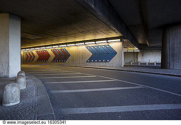 Germany  Berlin  Illuminated tunnel and empty asphalt road at Berlin Tegel Airport