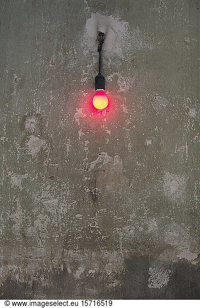 Germany  Berlin  Kreuzberg  Red light bulb on old wall
