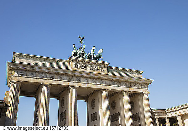 Germany  Berlin  Low angle view of Brandenburg Gate standing against clear blue sky