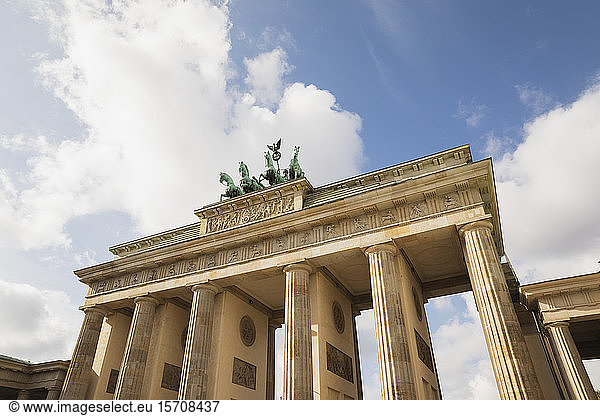 Germany  Berlin  Low angle view of Brandenburg Gate standing against clouds