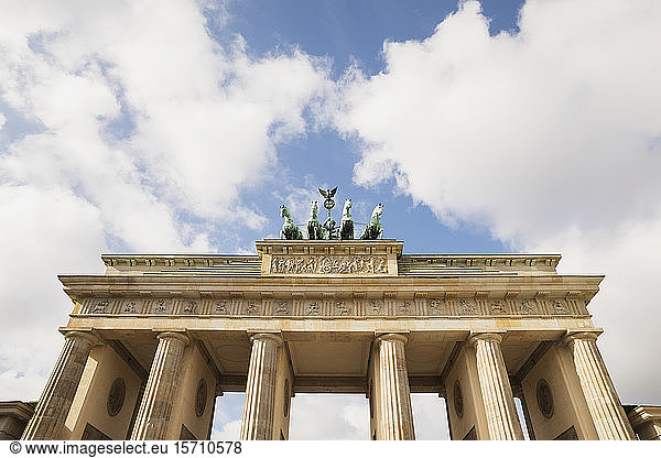 Germany  Berlin  Low angle view of Brandenburg Gate standing against clouds
