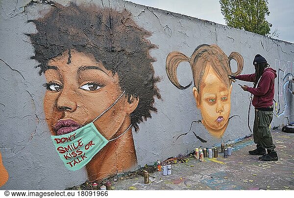 Germany  Berlin  15. 11. 2020  Mauerpark  graffiti wall  Caribbean Vandals  graffiti artist Eme Freethinker Jamaica at work  Europe