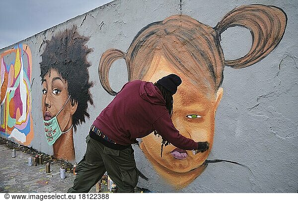 Germany  Berlin  15. 11. 2020  Mauerpark  graffiti wall  Caribbean Vandals  graffiti artist Eme Freethinker Jamaica at work  Europe