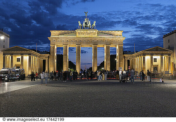Germany  Berlin  People gathering in front of Brandenburg Gate at night