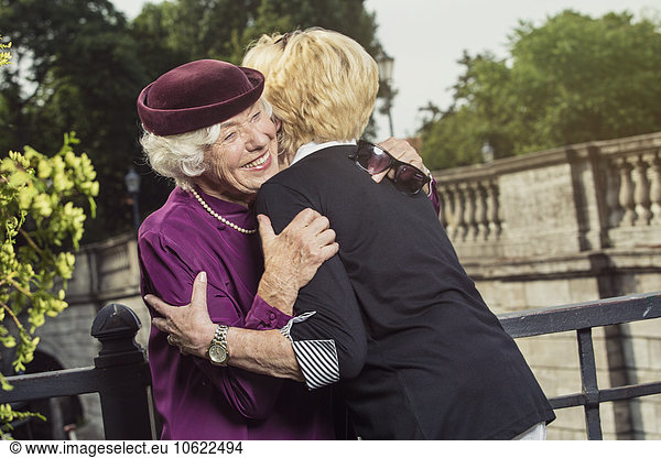 Germany  Berlin  portrait of two happy senior women hugging each other