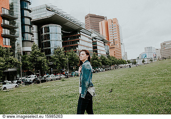 Germany  Berlin  Portrait of young woman posing outdoors in denim jacket