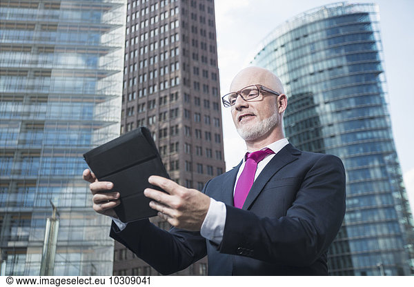 Germany  Berlin  Potsdam Square  business man with digital tablet