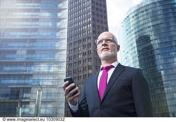 Germany  Berlin  Potsdam Square  business man with mobile phone