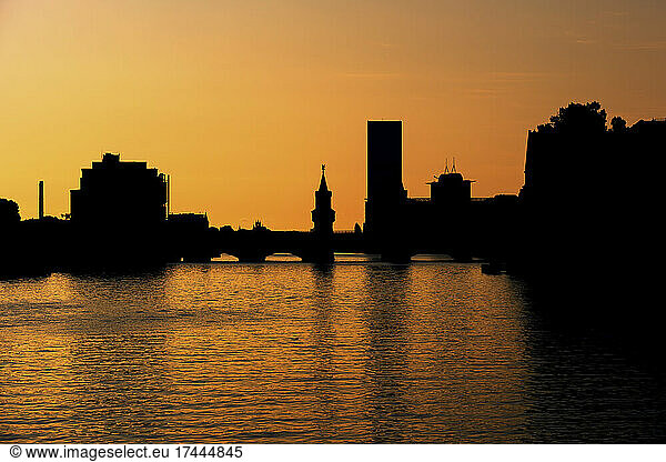 Germany  Berlin  River Spree canal and silhouette of Oberbaum Bridge at moody dusk