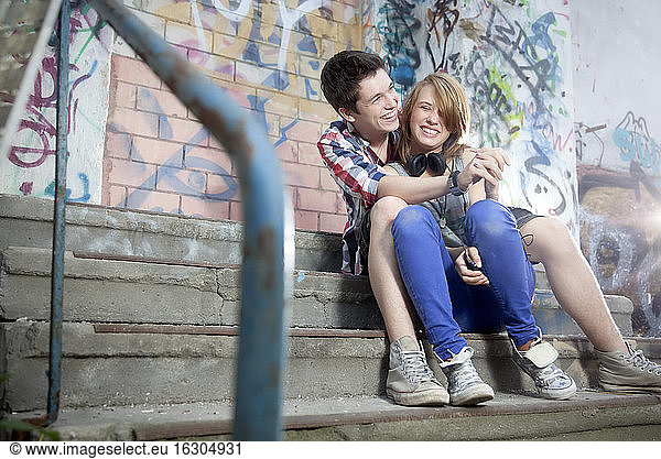 Germany  Berlin  Teenage boy and girl hugging  smiling