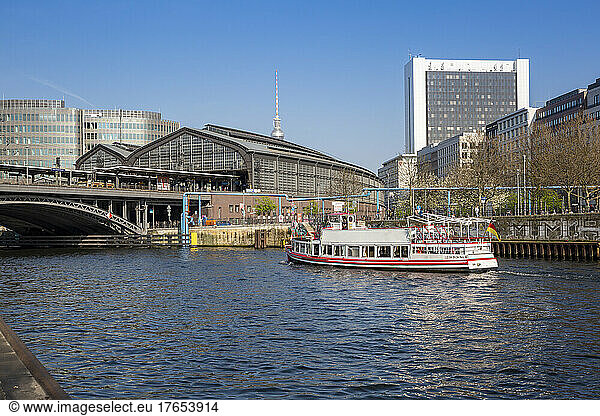 Germany  Berlin  Tourboat sailing along river Spree with Berlin Friedrichstrasse Station and Berlin Television Tower in background