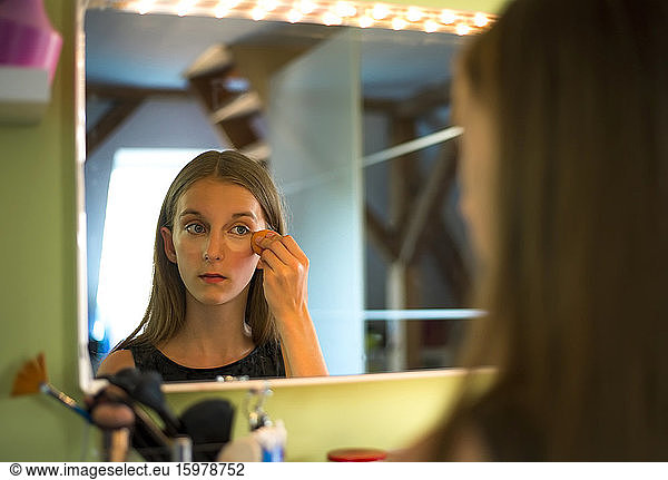 Germany  Brandenburg  Teenage girl applying make up