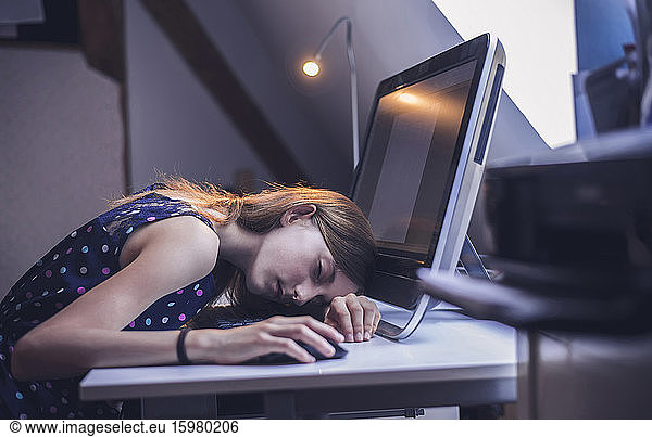 Germany  Brandenburg  Teenage girl falling asleep while using computer