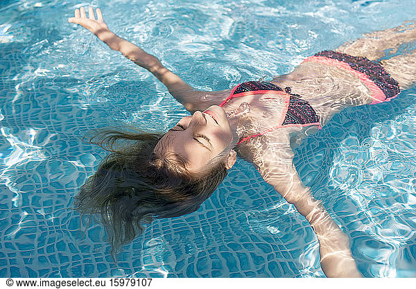 Germany  Brandenburg  Teenage girl floating in pool