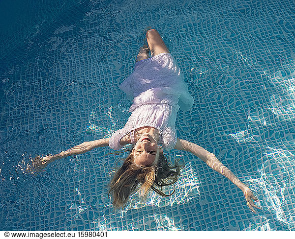 Germany  Brandenburg  Teenage girl floating in pool