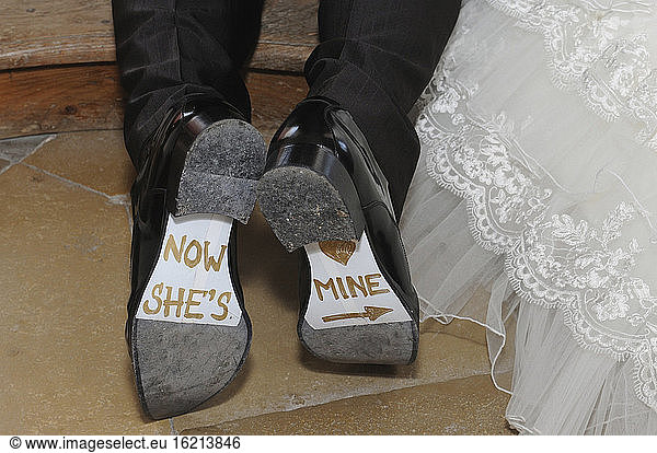 Germany  Bridal couple  Writing on shoes  close-up