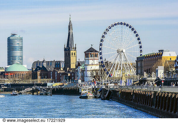 Germany  Dusseldorf  Architecture and Ferris wheel on riverbank