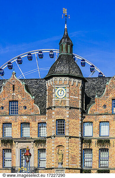 Germany  Dusseldorf  Facade with clock and Ferris wheel in the background