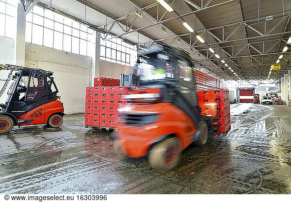 Germany  fork lift loading pallets of beer crates in a brewery