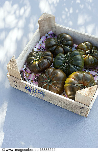 Germany  Green tomatoes in wooden box