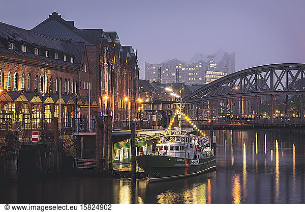 Germany  Hamburg  Boat moored in front of bridge over Elbe canal with Elbphilharmonie in background