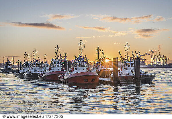 Germany  Hamburg  Boats moored in Neumuhlen at sunset in winter