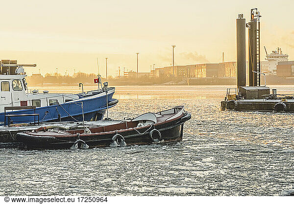 Germany  Hamburg  Boats moored in Neumuhlen at sunset in winter