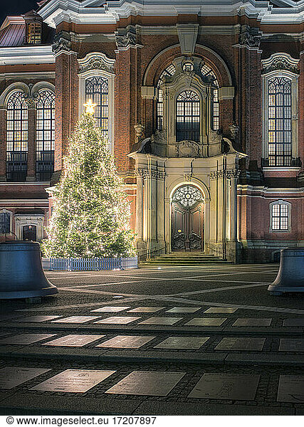 Germany  Hamburg  Christmas tree glowing in front of Saint Michaels Church at night