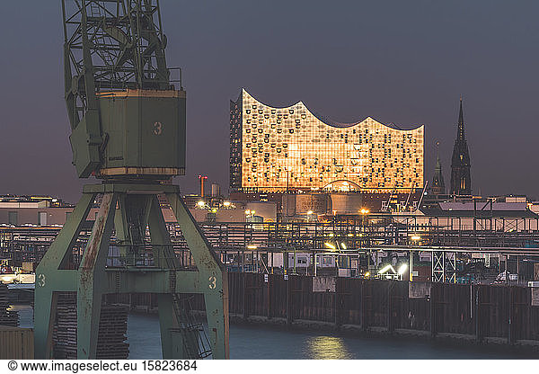 Germany  Hamburg  Harbor crane and Elbphilharmonie hall at dusk