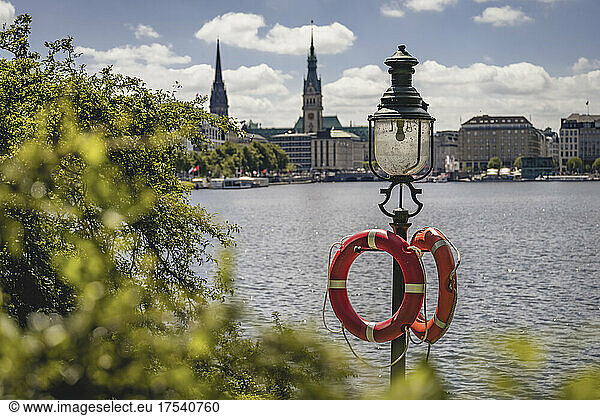 Germany  Hamburg  Life belts hanging on street light standing on shore of Inner Alster Lake