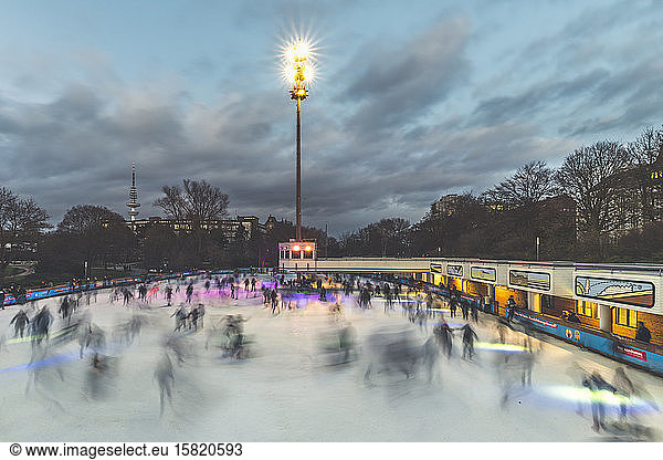 Germany  Hamburg  People ice-skating in Planten un Blomen park at dusk