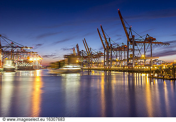 Germany  Hamburg  Port of Hamburg  Container Terminal  container cranes and container ships in the evening