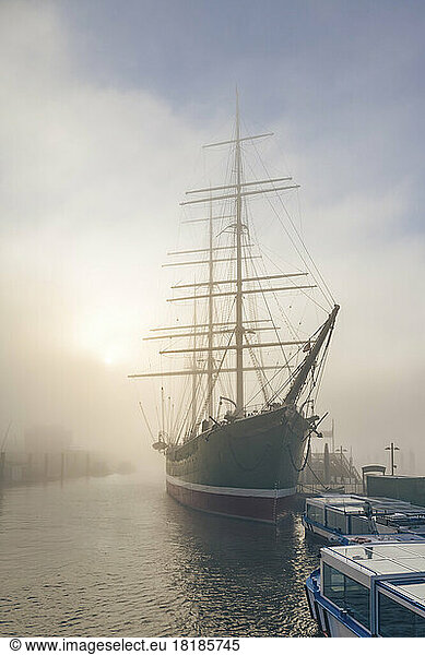 Germany  Hamburg  Rickmer Rickmers ship moored in harbor at foggy sunrise
