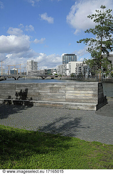 Germany  Hamburg  Riverbank benches in HafenCity with bridge and modern apartments in background