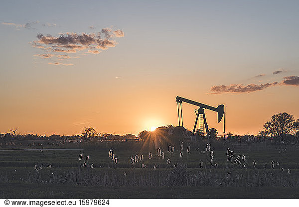 Germany  Hamburg  Silhouette of oil well at sunset