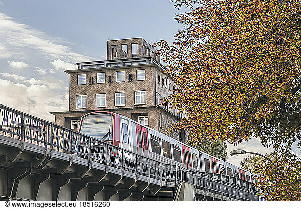 Germany  Hamburg  Subway train passing city bridge in autumn