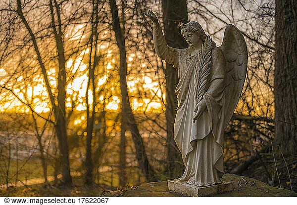 Germany  Hesse  Brechen  Outdoor angel statue at sunrise