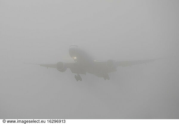 Germany  Hesse  Frankfurt  Landing airplane in fog