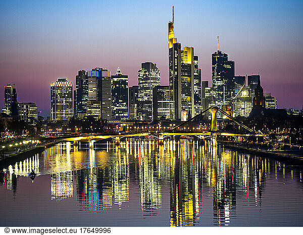 Germany  Hesse  Frankfurt  River Main canal at dusk with bridge and downtown skyscrapers in background