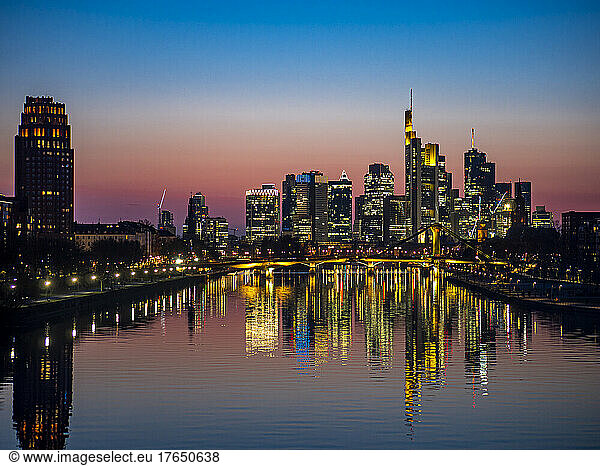 Germany  Hesse  Frankfurt  River Main canal at dusk with bridge and downtown skyscrapers in background