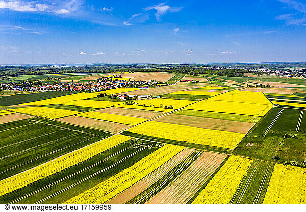 Germany  Hesse  Munzenberg  Helicopter view of countryside village and surrounding fields in summer