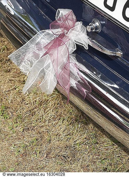 Germany  Hesse  Vintage car decorated with ribbon