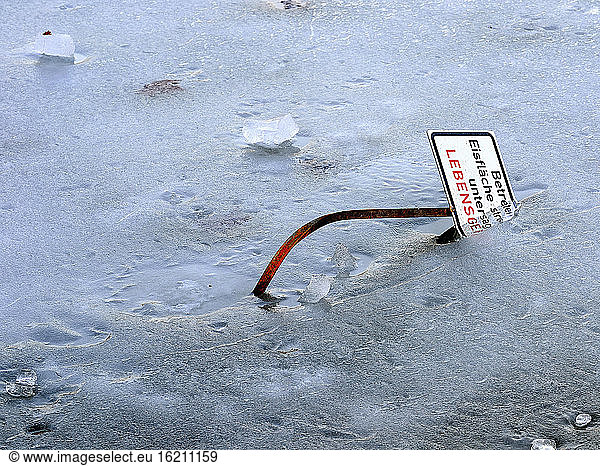 Germany  Hesse  Wiesbaden  Ice warning sign in frozen ice