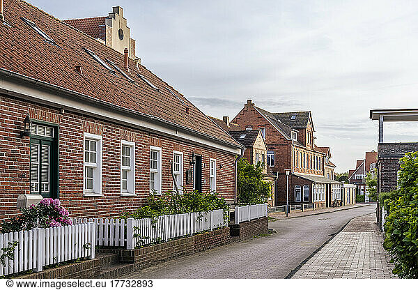 Germany  Lower Saxony  Juist  Empty street stretching in front of brick town houses