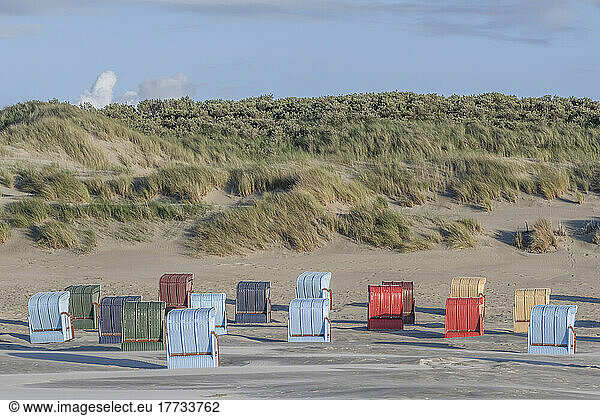Germany  Lower Saxony  Juist  Hooded beach chairs in front of grassy dunes