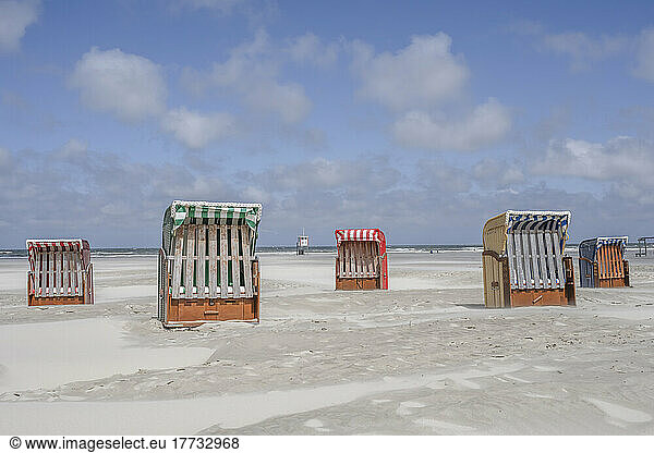 Germany  Lower Saxony  Juist  Hooded beach chairs on empty beach