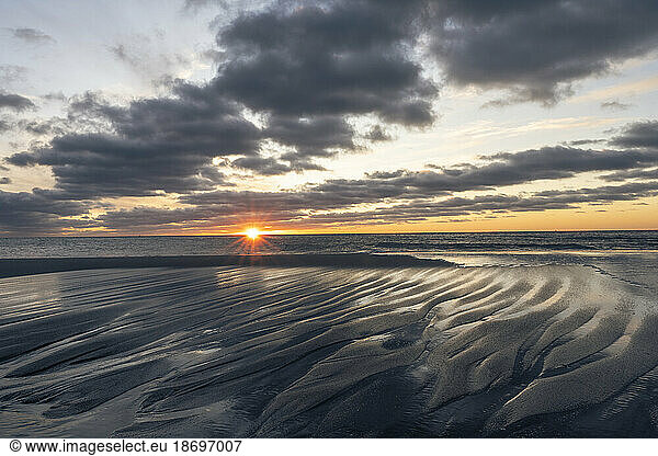 Germany  Mecklenburg-Vorpommern  Wustrow  Clouds over edge of sandy beach at sunset