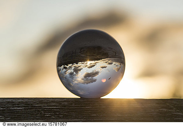 Germany  Mecklenburg-West Pomerania  Prerow  Shiny glass ball against rising sun