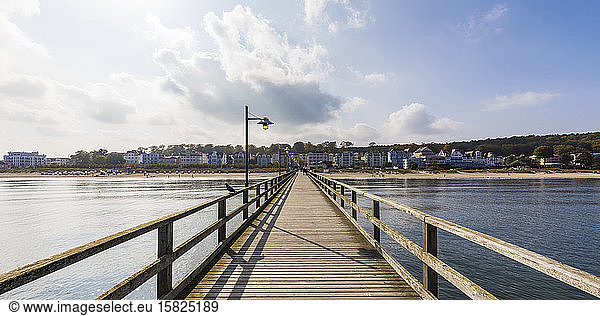 Germany  Mecklenburg-Western Pomerania  Heringsdorf  Diminishing perspective of wooden pier with town in background